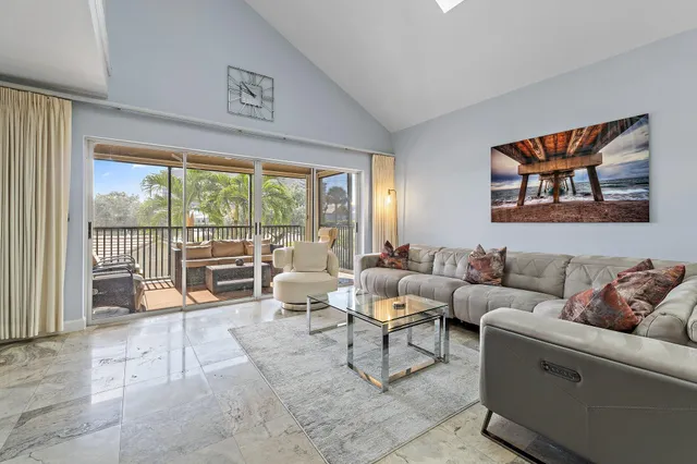 a bedroom with furniture and a large window