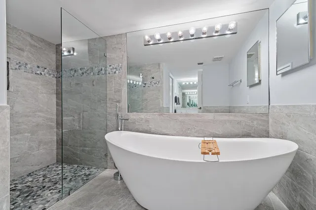 a bedroom with a large bed and a flat screen tv