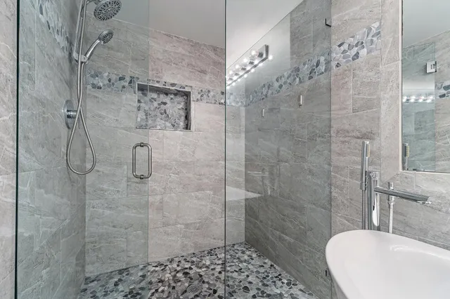 a bathroom with a granite countertop sink mirror vanity and toilet