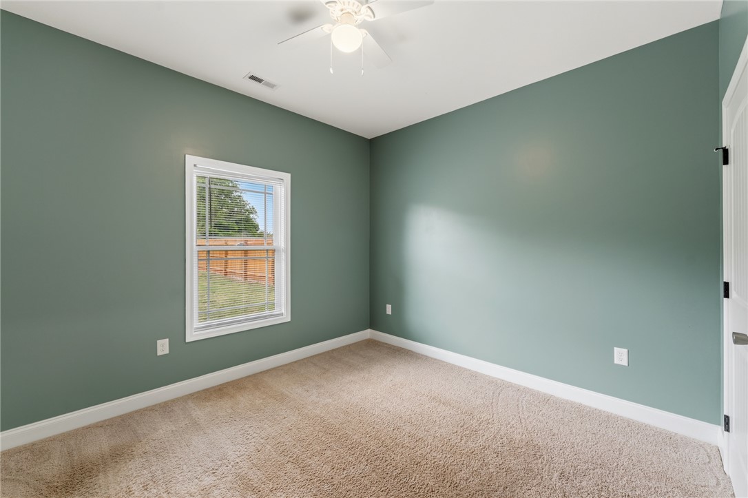 1411 Dunn Road Anderson, SC 29625 - Photo 24 of 30 This cozy bedroom features carpeted flooring and a window, creating a serene and comfortable retreat.