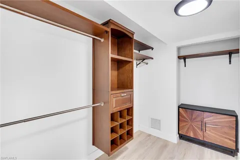 a view of walk in closet with empty racks