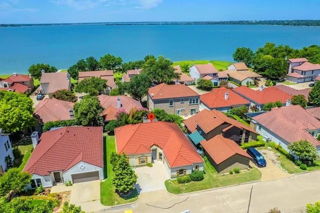 an aerial view of multiple houses with yard