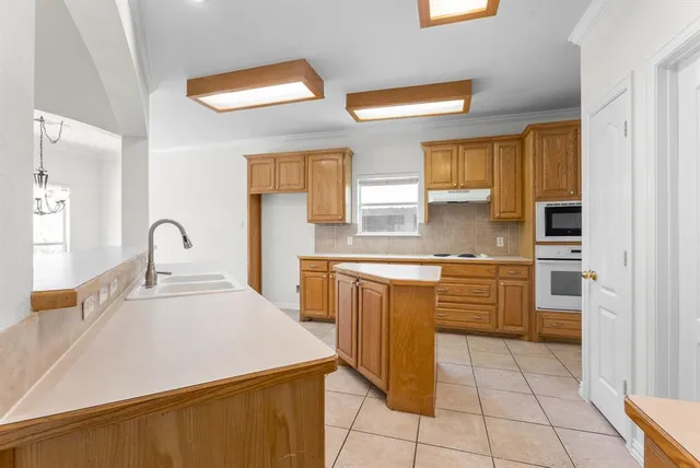 a kitchen with stainless steel appliances granite countertop a sink and a stove