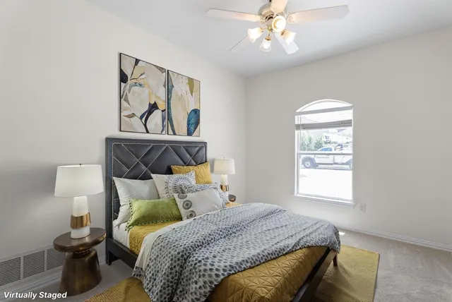 a bedroom with a bed and a window