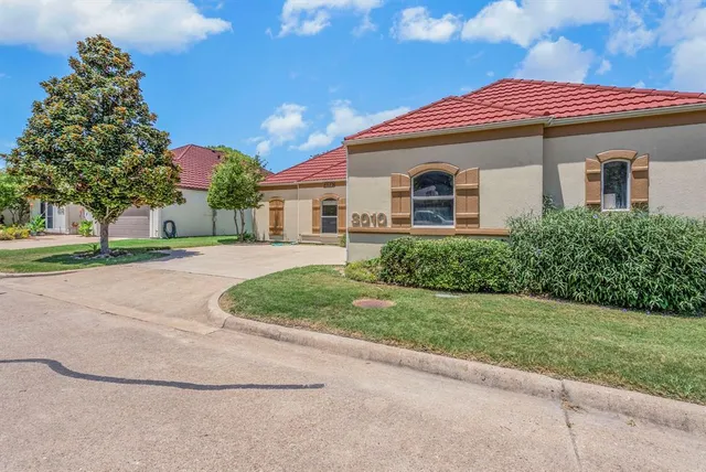 a front view of house with yard and green space