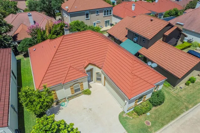 a aerial view of a house with a yard and plants