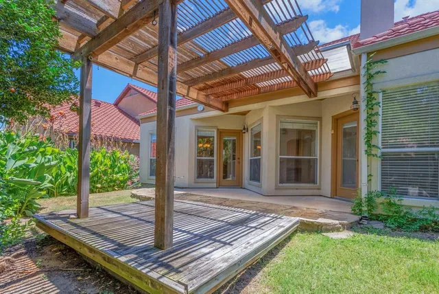 a view of a house with backyard and wooden floor