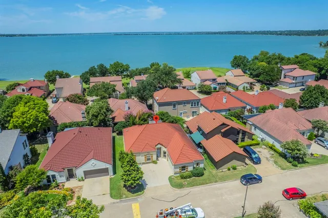 an aerial view of residential houses with outdoor space and swimming pool