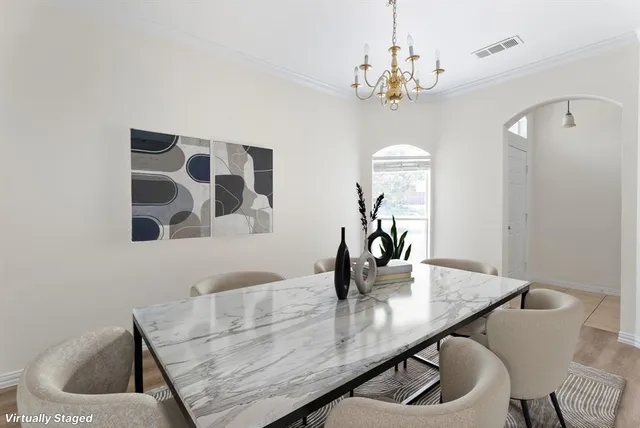 a view of a dining room with furniture and chandelier