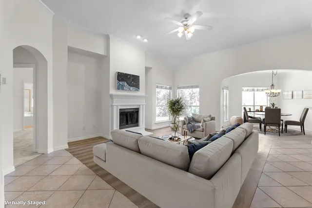 a living room with furniture a fireplace and a flat screen tv