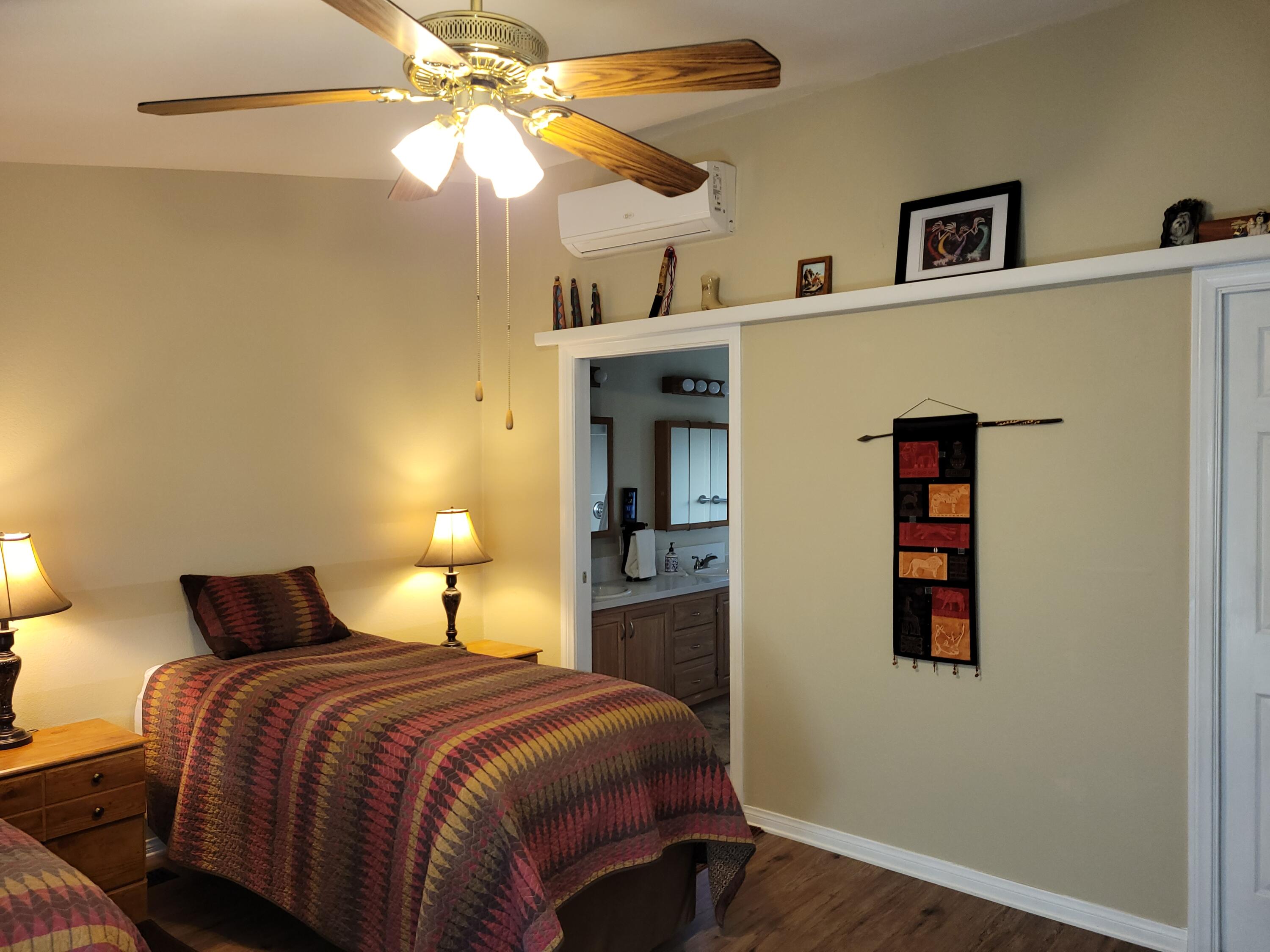 81641 Ave 48, Unit 56 Indio, CA 92201 - Photo 11 of 28 a bedroom with a bed and a chandelier
