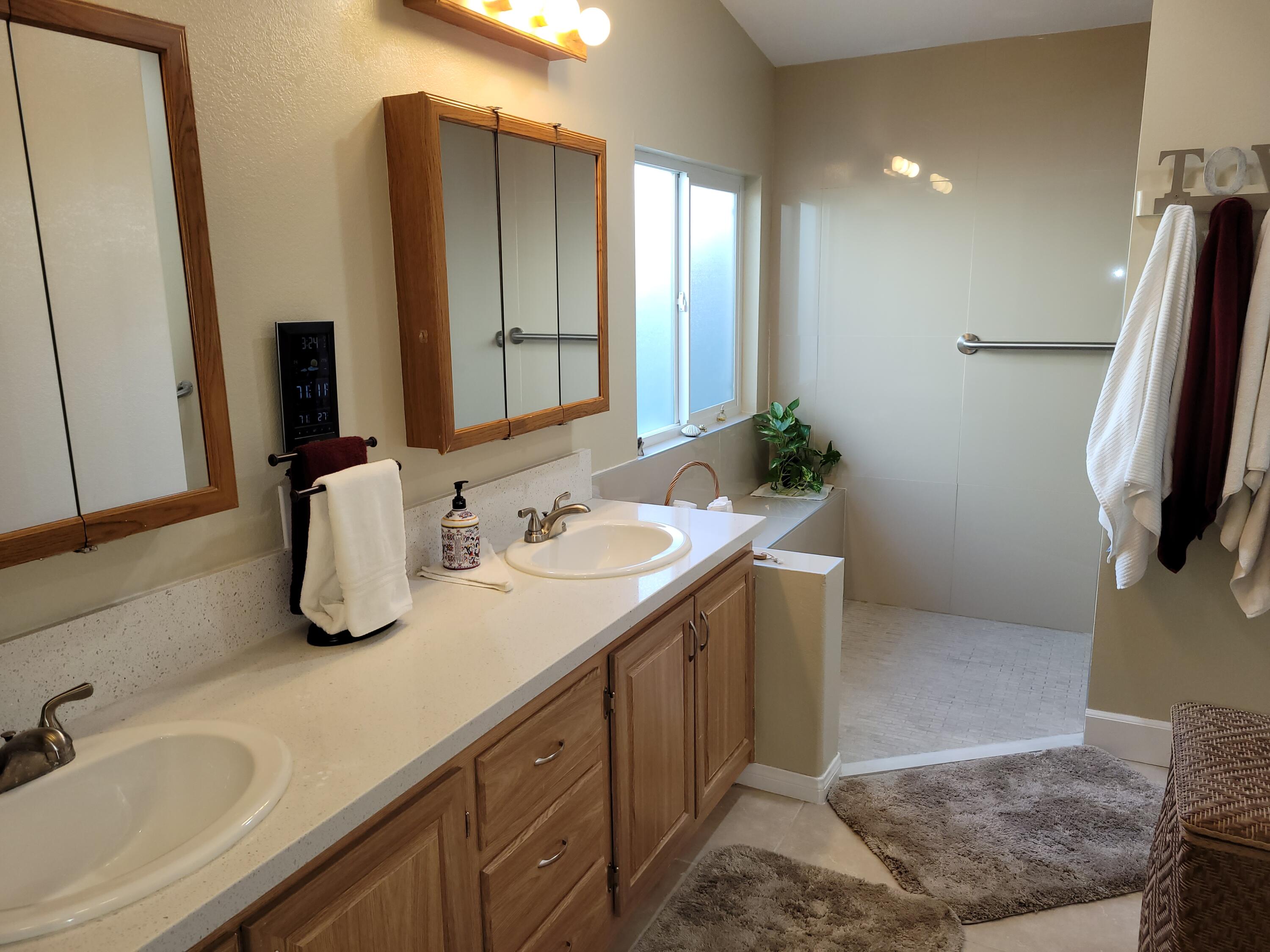 81641 Ave 48, Unit 56 Indio, CA 92201 - Photo 12 of 28 a bathroom with double vanity sink and mirror