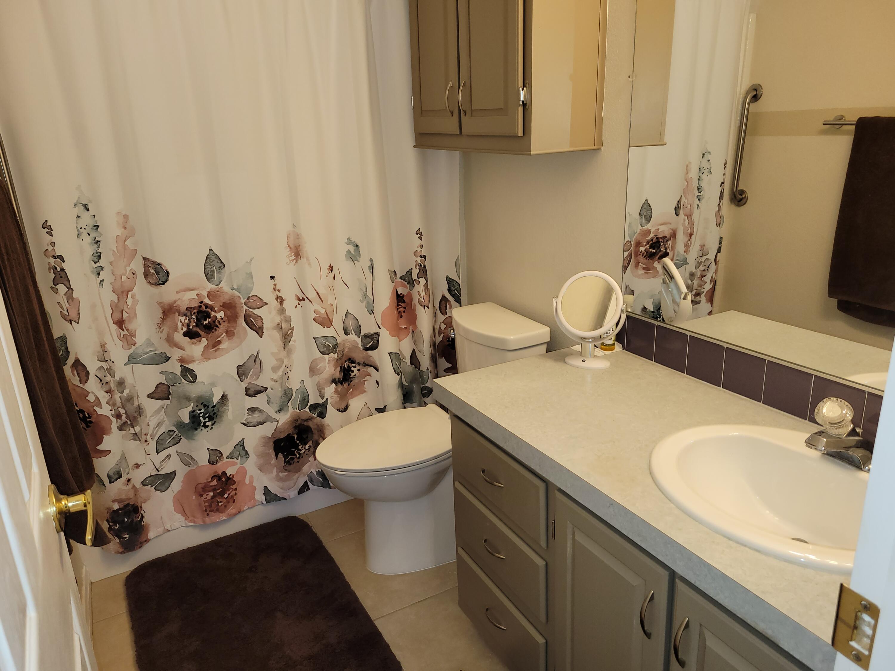 81641 Ave 48, Unit 56 Indio, CA 92201 - Photo 16 of 28 a bathroom with a sink toilet and shower