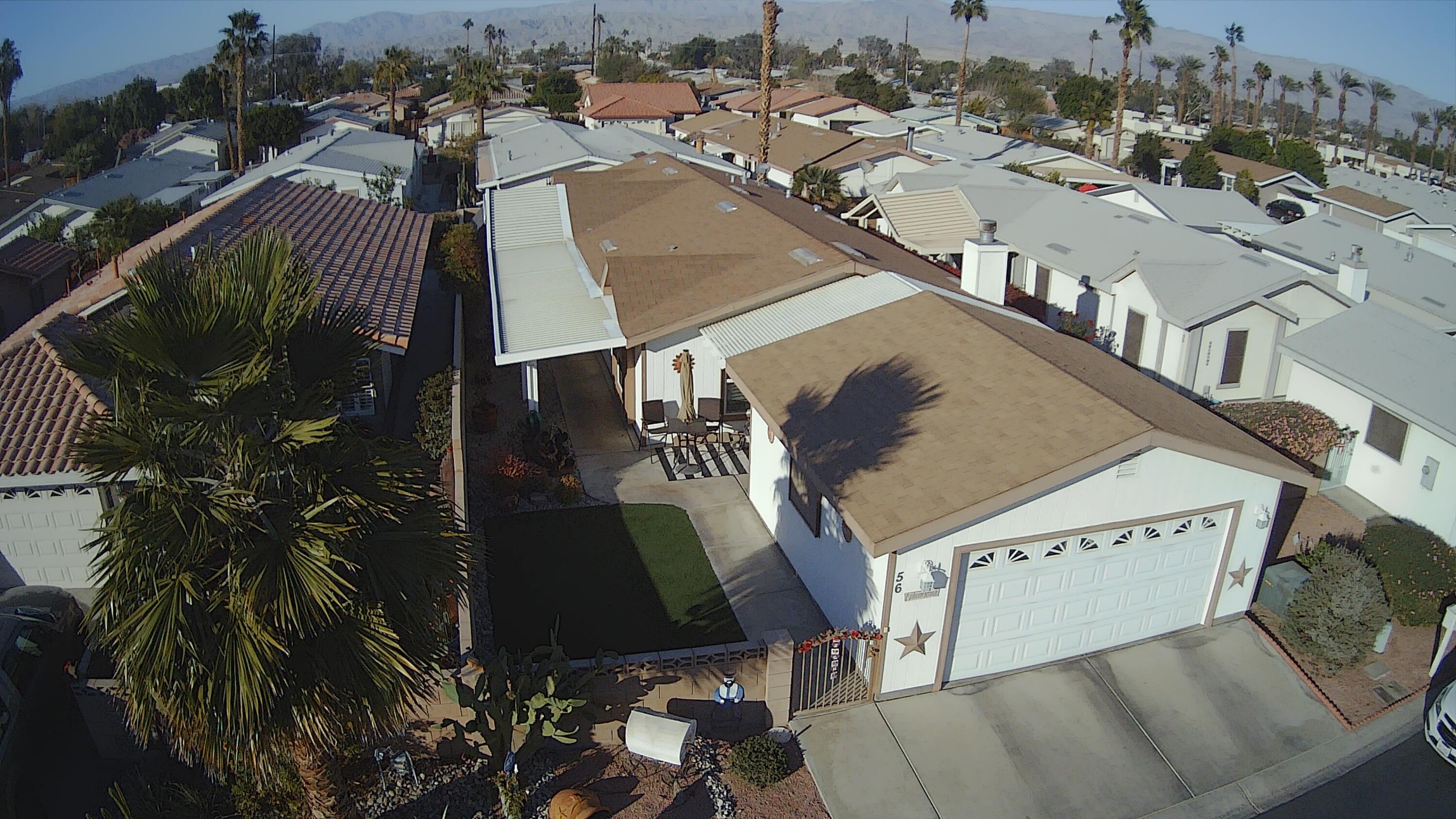 81641 Ave 48, Unit 56 Indio, CA 92201 - Photo 22 of 28 an aerial view of a residential apartment building with a yard
