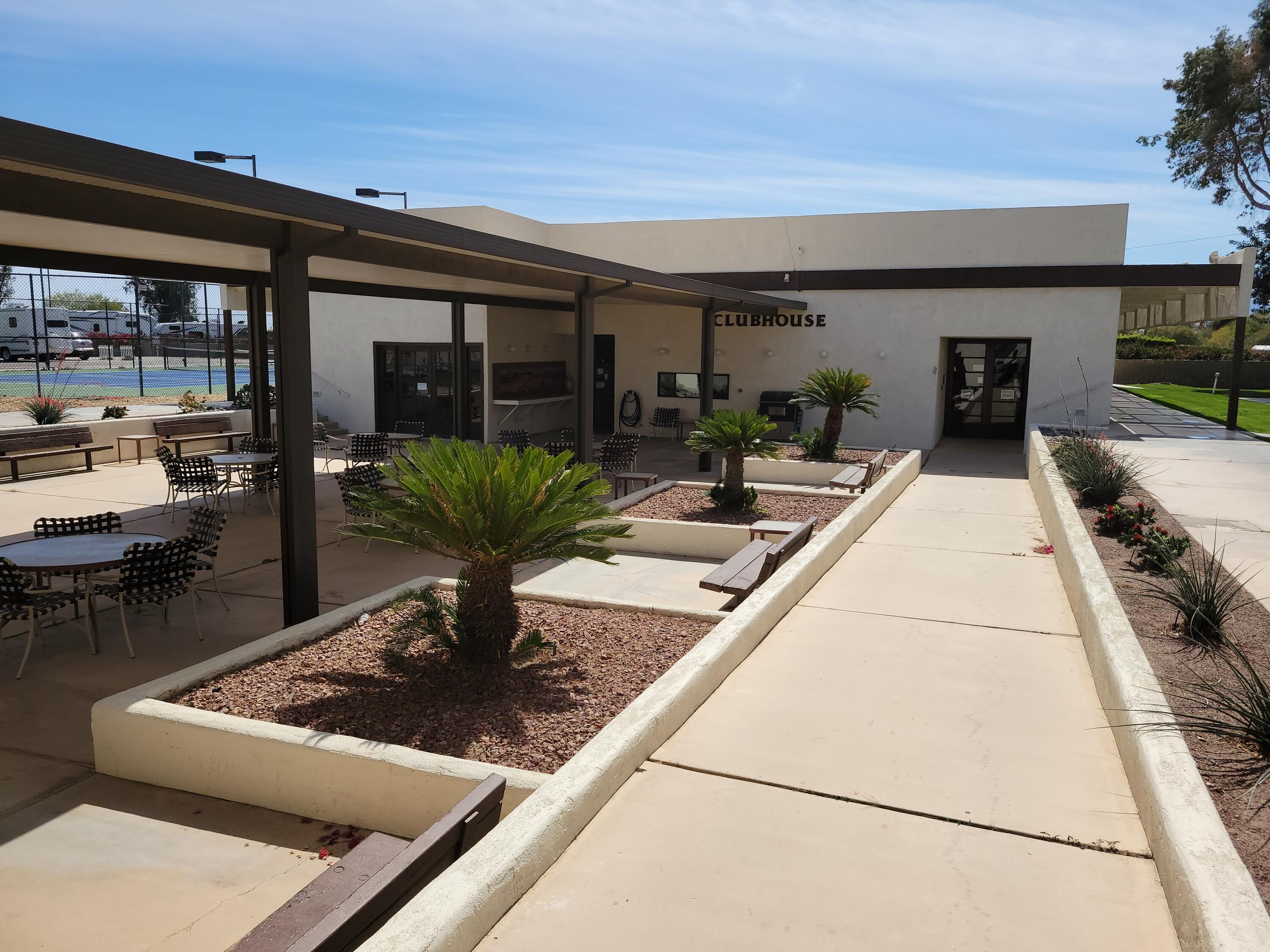 81641 Ave 48, Unit 56 Indio, CA 92201 - Photo 25 of 28 a view of a patio with couches table and chairs with potted plants