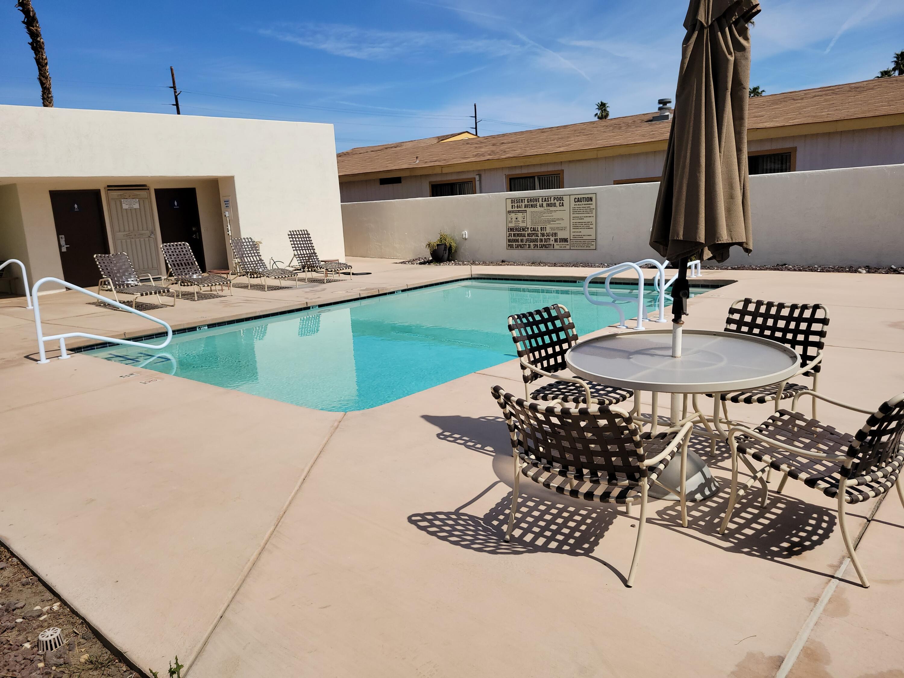 81641 Ave 48, Unit 56 Indio, CA 92201 - Photo 26 of 28 a table and chairs in front of the house