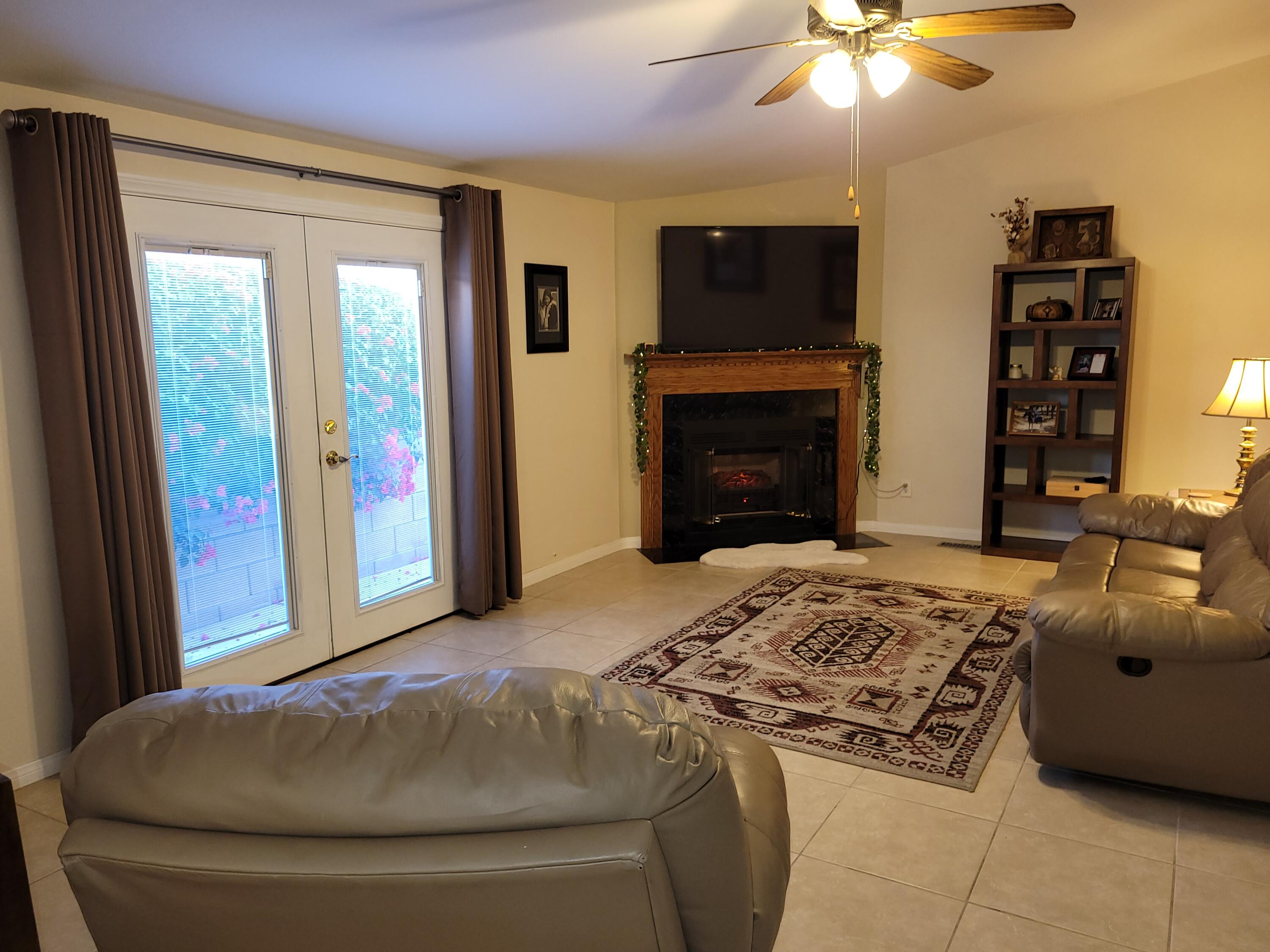 81641 Ave 48, Unit 56 Indio, CA 92201 - Photo 7 of 28 a living room with a couch and a fireplace