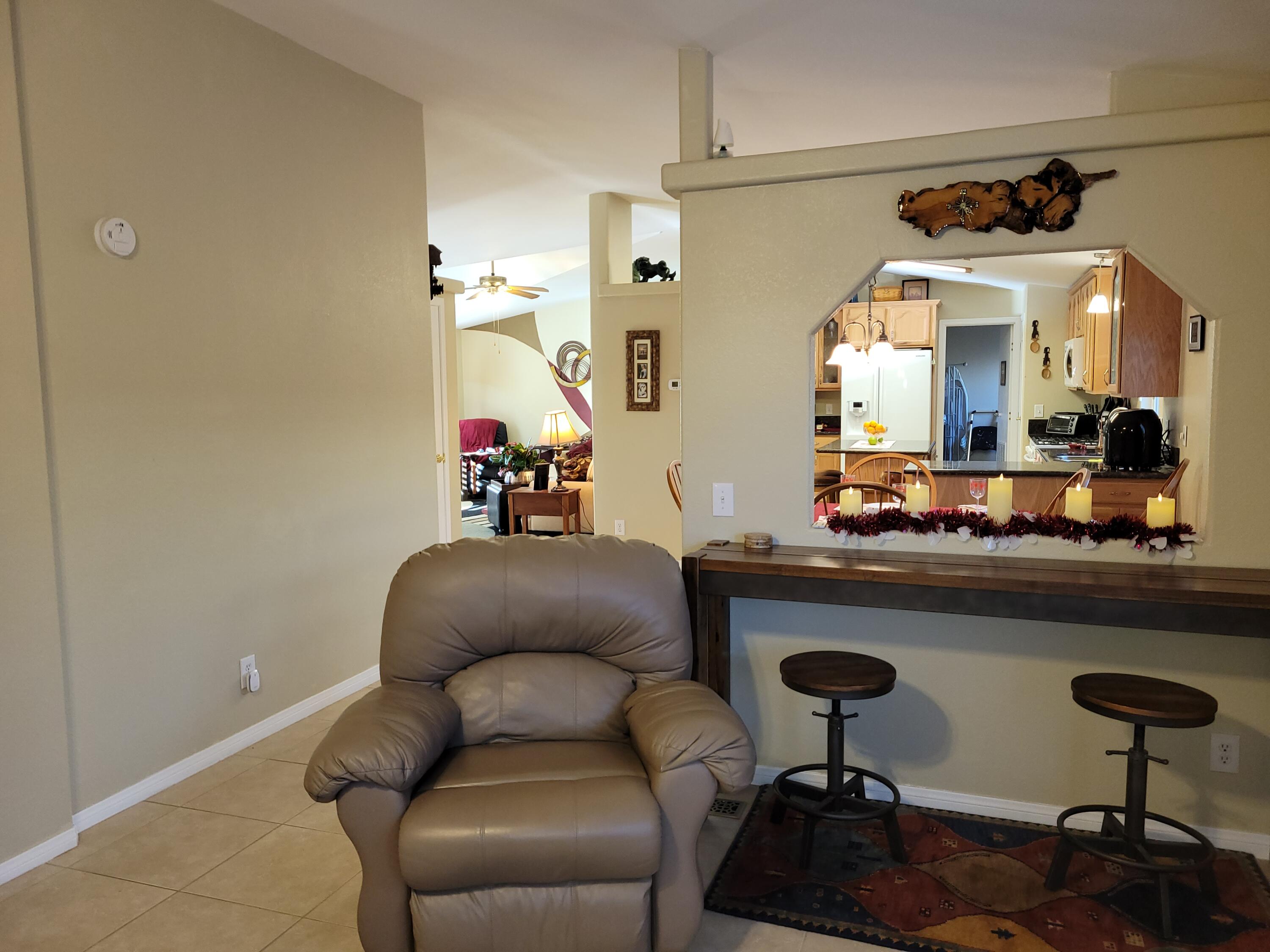 81641 Ave 48, Unit 56 Indio, CA 92201 - Photo 9 of 28 a living room with furniture and a wooden floor
