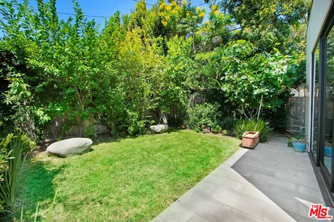 a view of a table and chairs in the garden