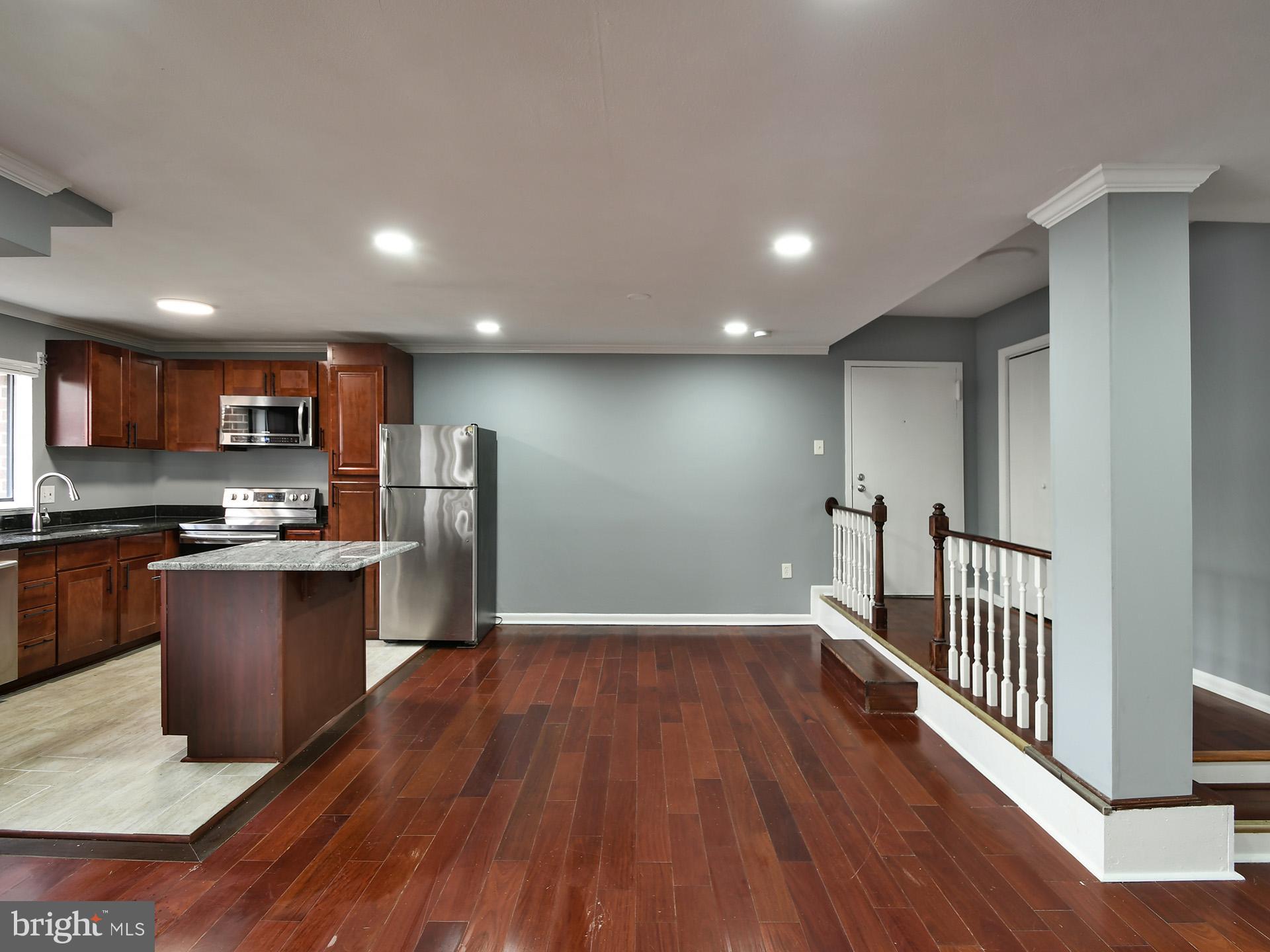 15712 Dorset Road, Unit 104 Laurel, MD 20707 - Photo 11 of 49 a view of kitchen with stainless steel appliances granite countertop refrigerator stove microwave and wooden floor