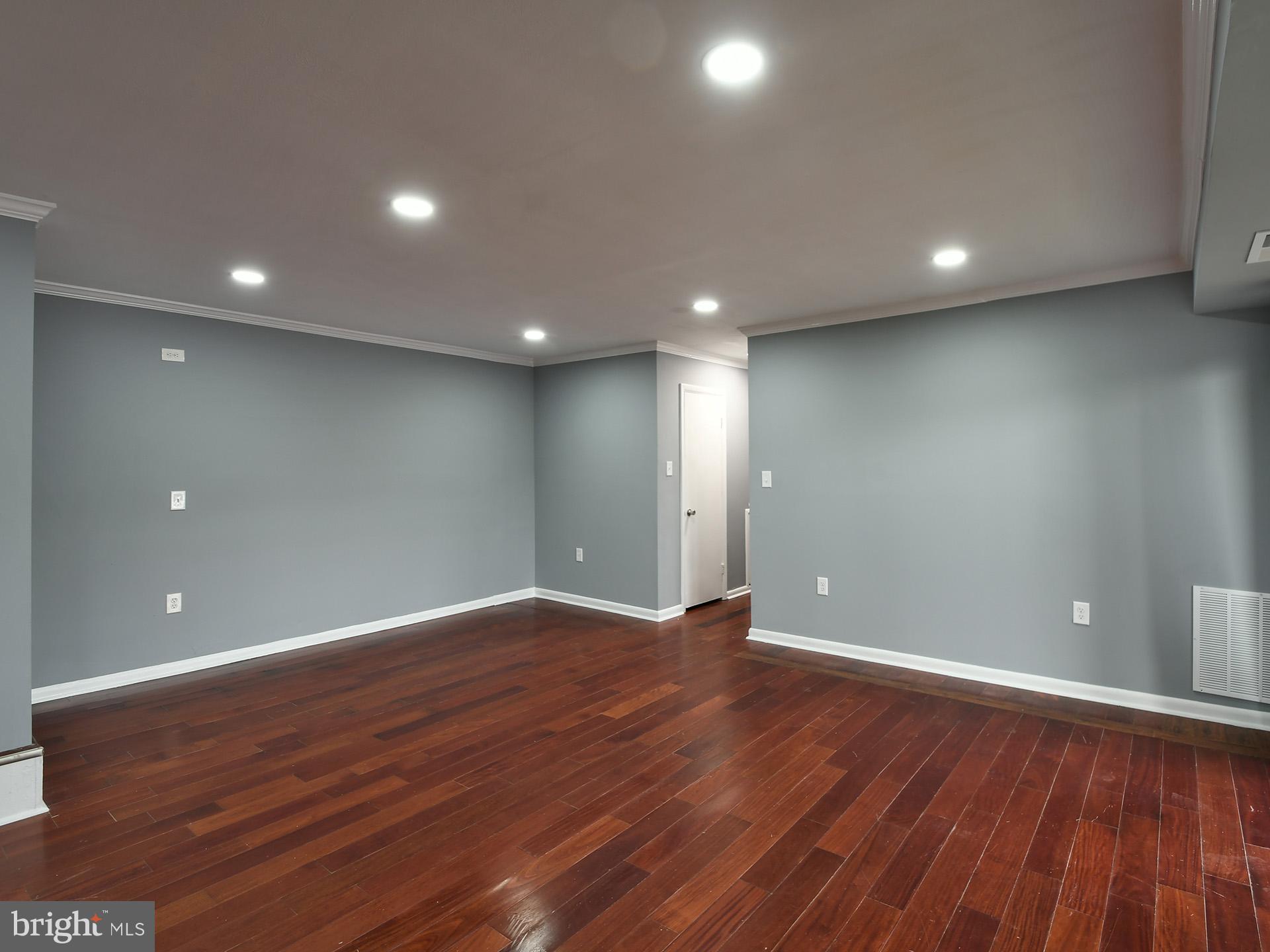 15712 Dorset Road, Unit 104 Laurel, MD 20707 - Photo 23 of 49 a view of an empty room with wooden floor and entryway