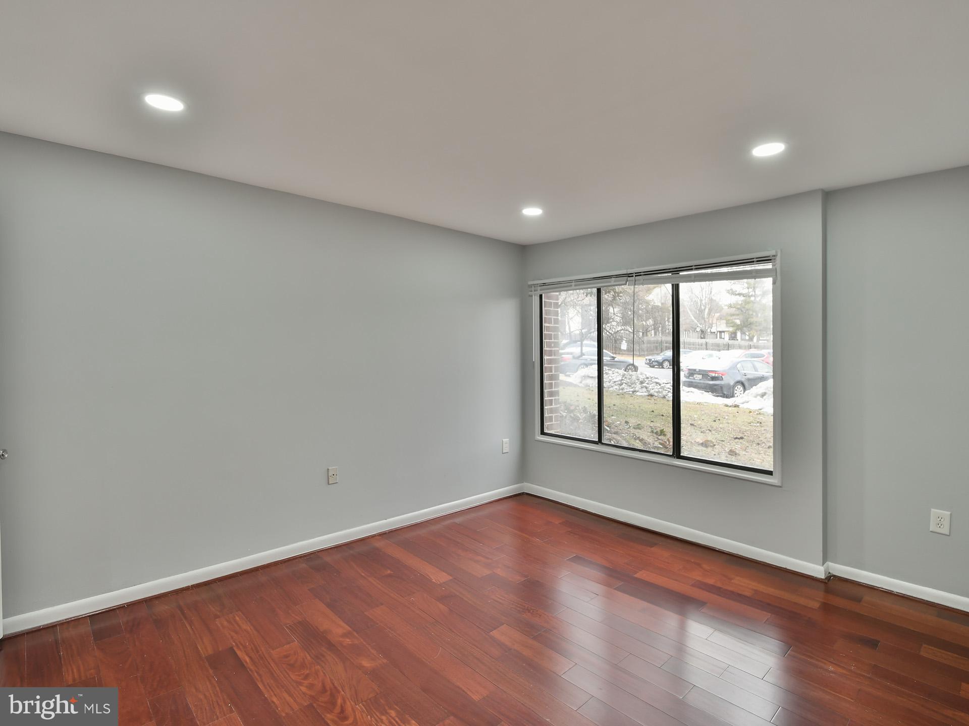 15712 Dorset Road, Unit 104 Laurel, MD 20707 - Photo 24 of 49 an empty room with wooden floor and windows