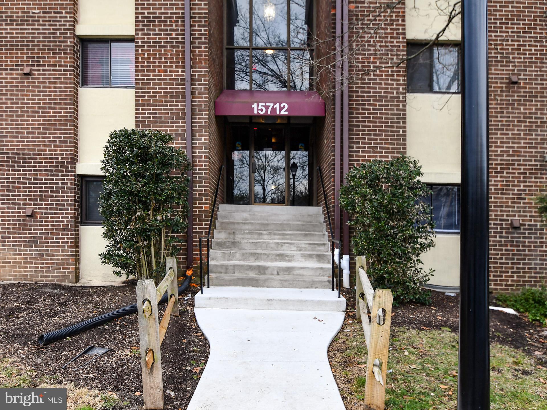 15712 Dorset Road, Unit 104 Laurel, MD 20707 - Photo 3 of 49 a front view of a house with a garden