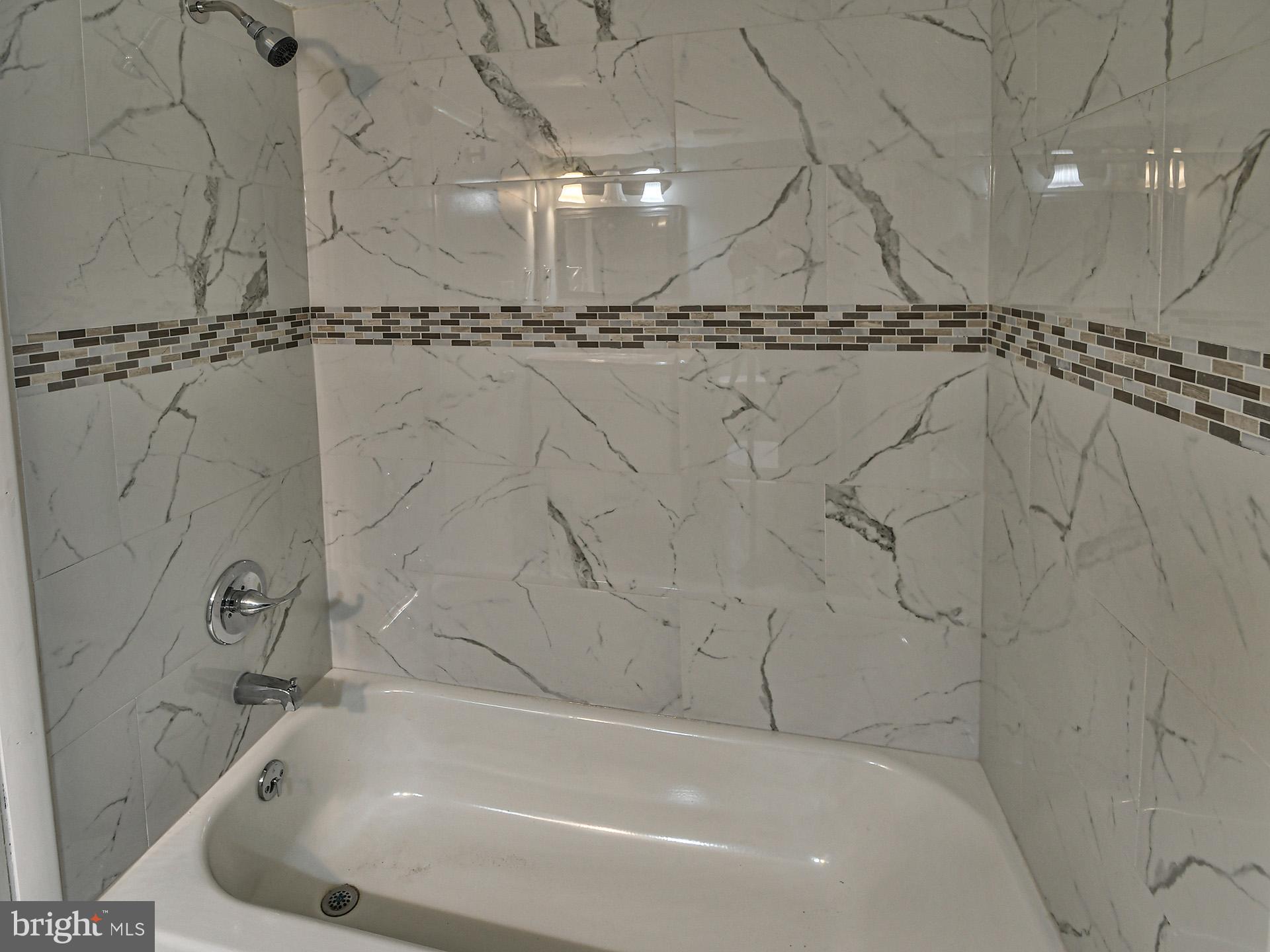 15712 Dorset Road, Unit 104 Laurel, MD 20707 - Photo 33 of 49 a bathroom with a bathtub and a shower