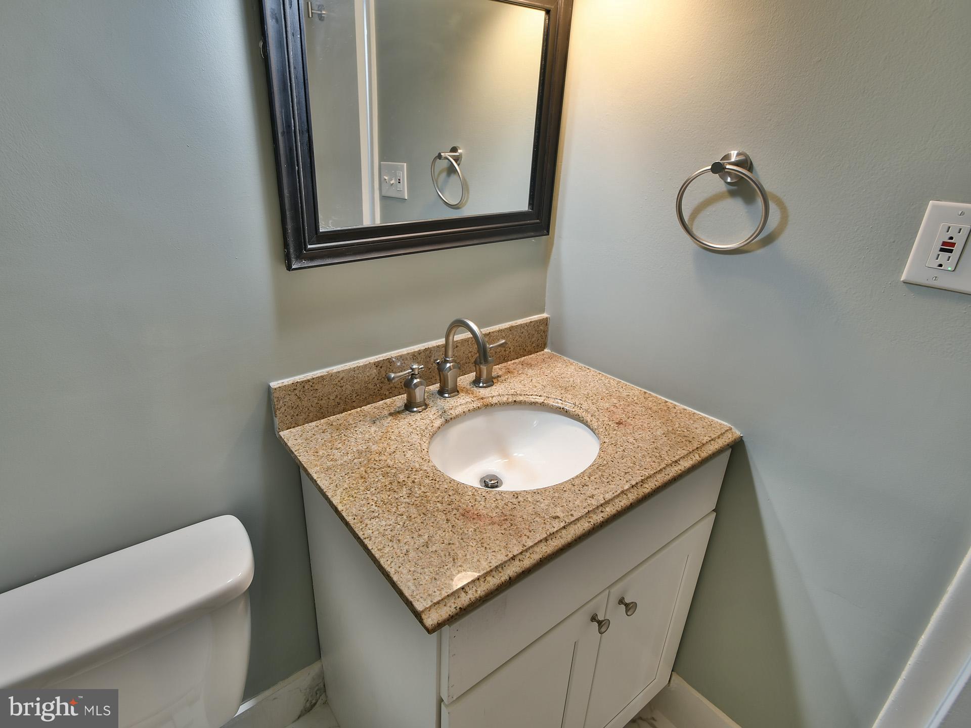 15712 Dorset Road, Unit 104 Laurel, MD 20707 - Photo 34 of 49 a bathroom with a granite countertop sink and a mirror