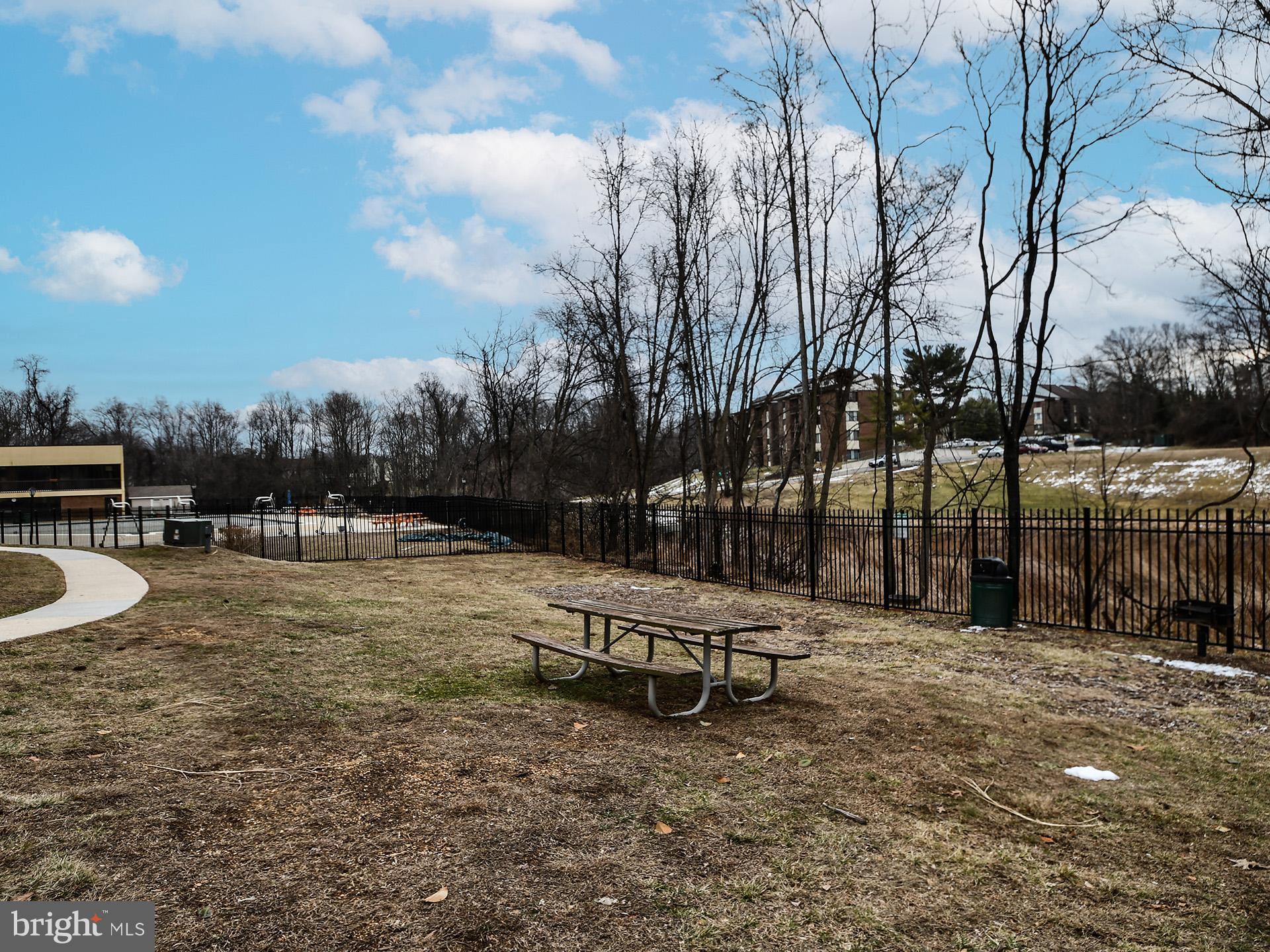15712 Dorset Road, Unit 104 Laurel, MD 20707 - Photo 46 of 49 a backyard of a house with table and chairs
