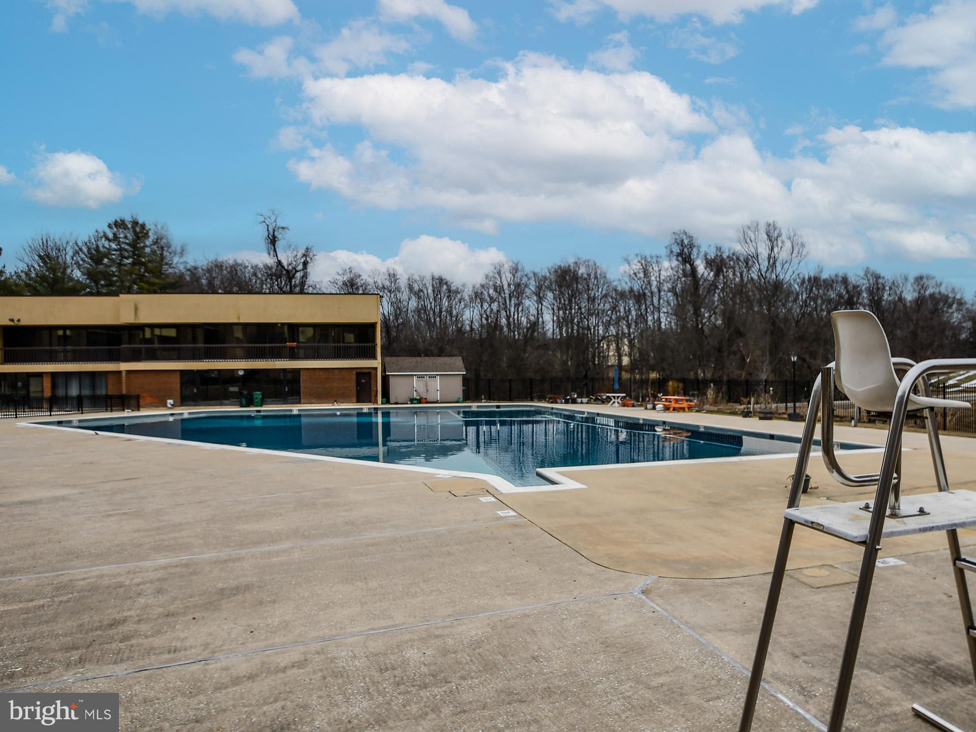 15712 Dorset Road, Unit 104 Laurel, MD 20707 - Photo 48 of 49 a view of a swimming pool with a chair and wooden floor