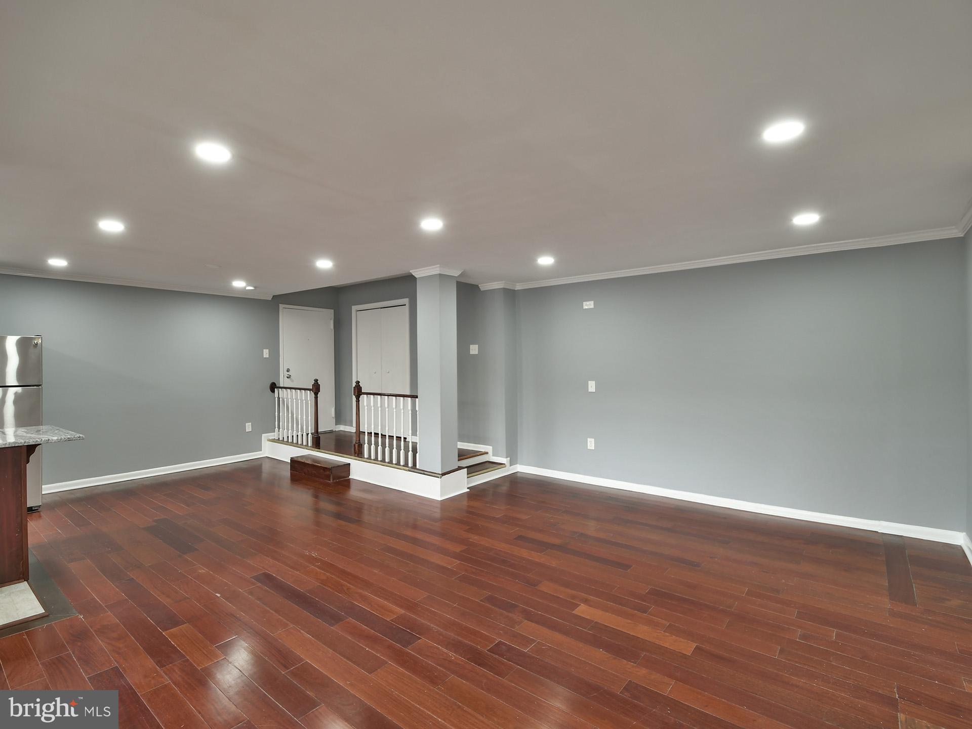 15712 Dorset Road, Unit 104 Laurel, MD 20707 - Photo 9 of 49 a view of an empty room with wooden floor