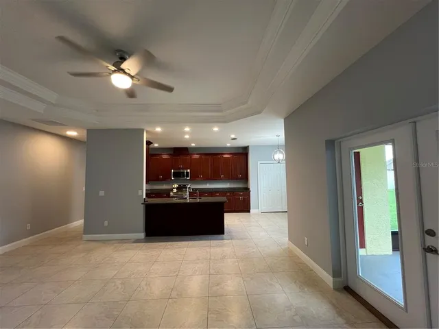 a large kitchen with a sink and stainless steel appliances