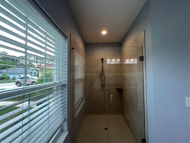 a bathroom with a shower and a sink