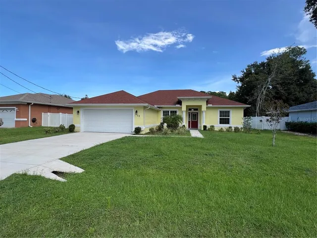 a view of a house with a backyard