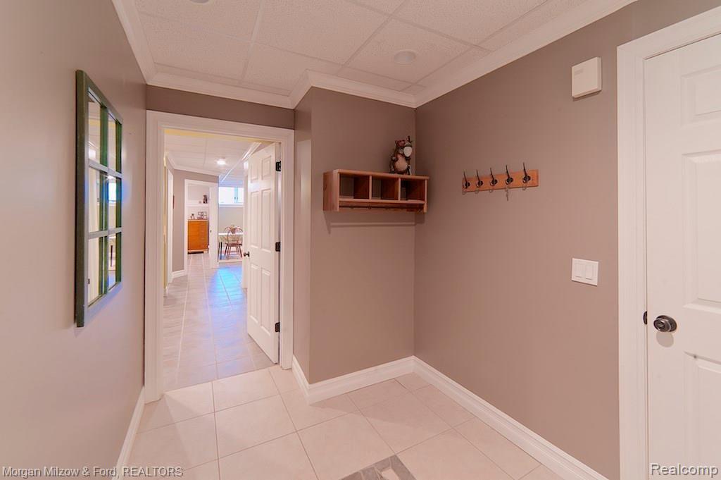 3595 Jossman Road Holly, MI 48442 - Photo 38 of 49 Lower level hallway & access to the attached garage
