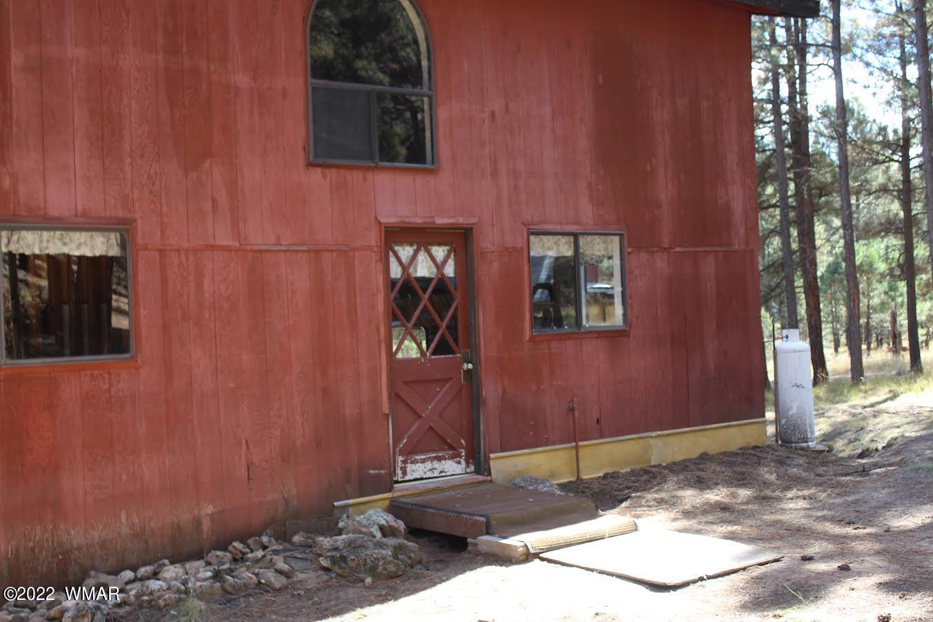 522 Forest Service 412 Road Overgaard, AZ 85933 - Photo 3 of 15 a house with a tree in front of it