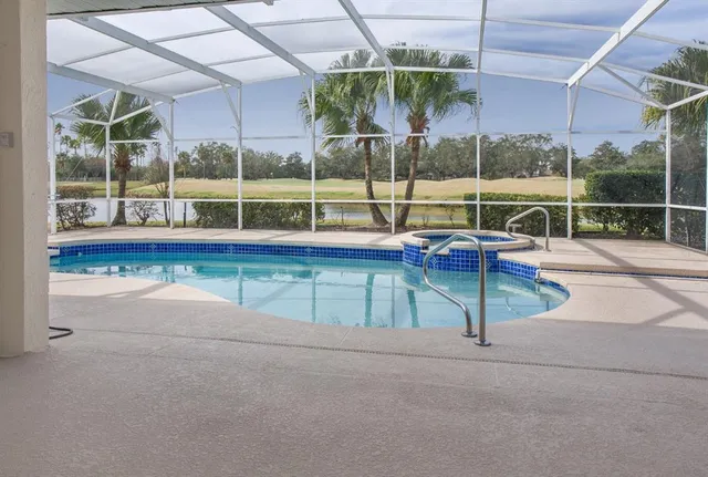 a view of a house with swimming pool and sitting area