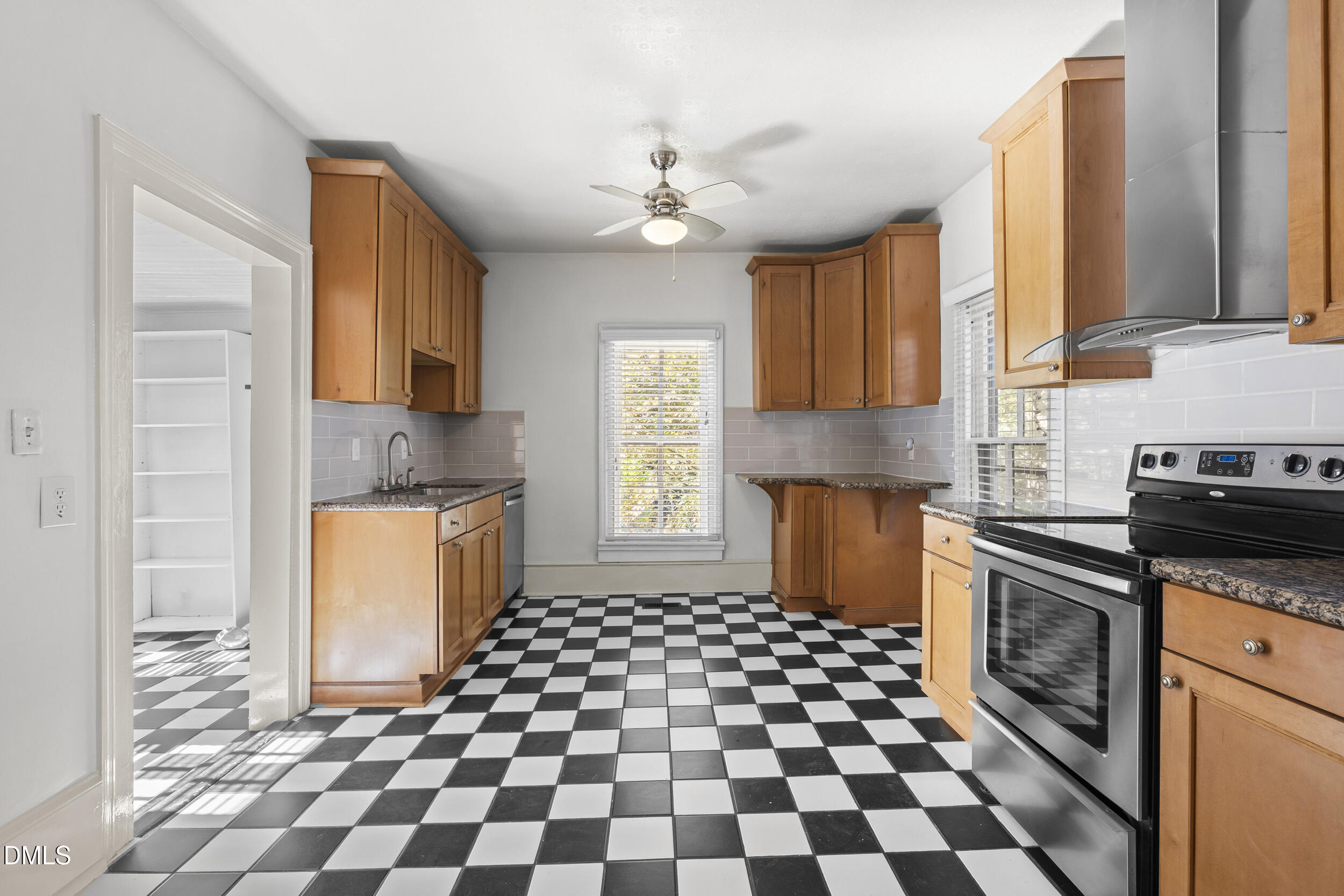 527 North East Street Raleigh, NC 27604 - Photo 14 of 46 a kitchen with a stove a sink and a cabinets