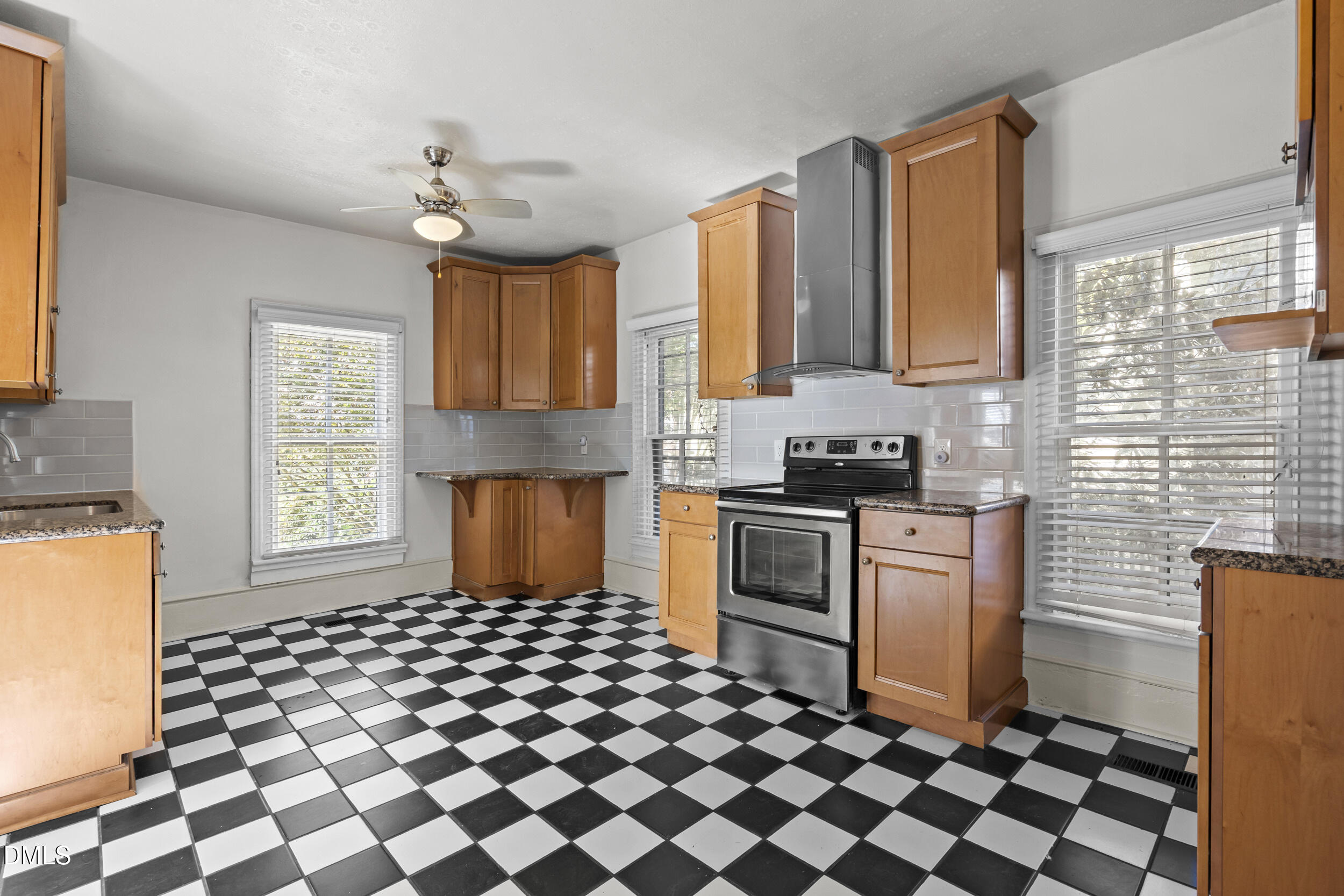 527 North East Street Raleigh, NC 27604 - Photo 15 of 46 a kitchen with granite countertop stainless steel appliances a stove a sink and a microwave