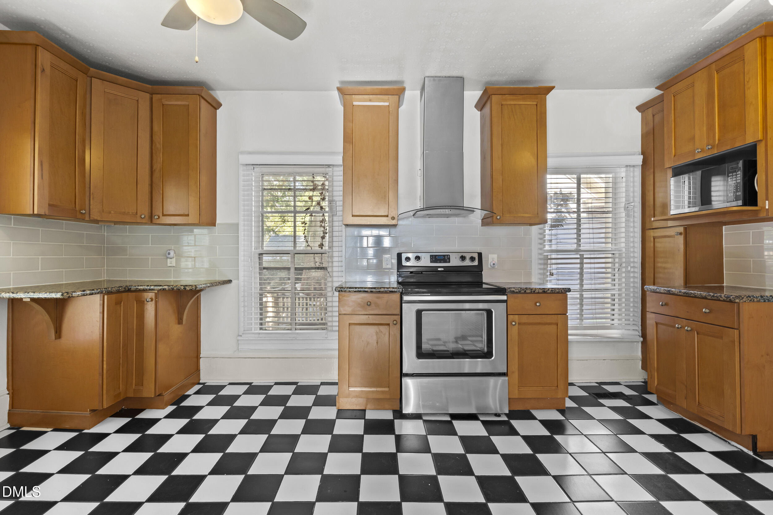 527 North East Street Raleigh, NC 27604 - Photo 16 of 46 a kitchen with a stove a sink and a refrigerator