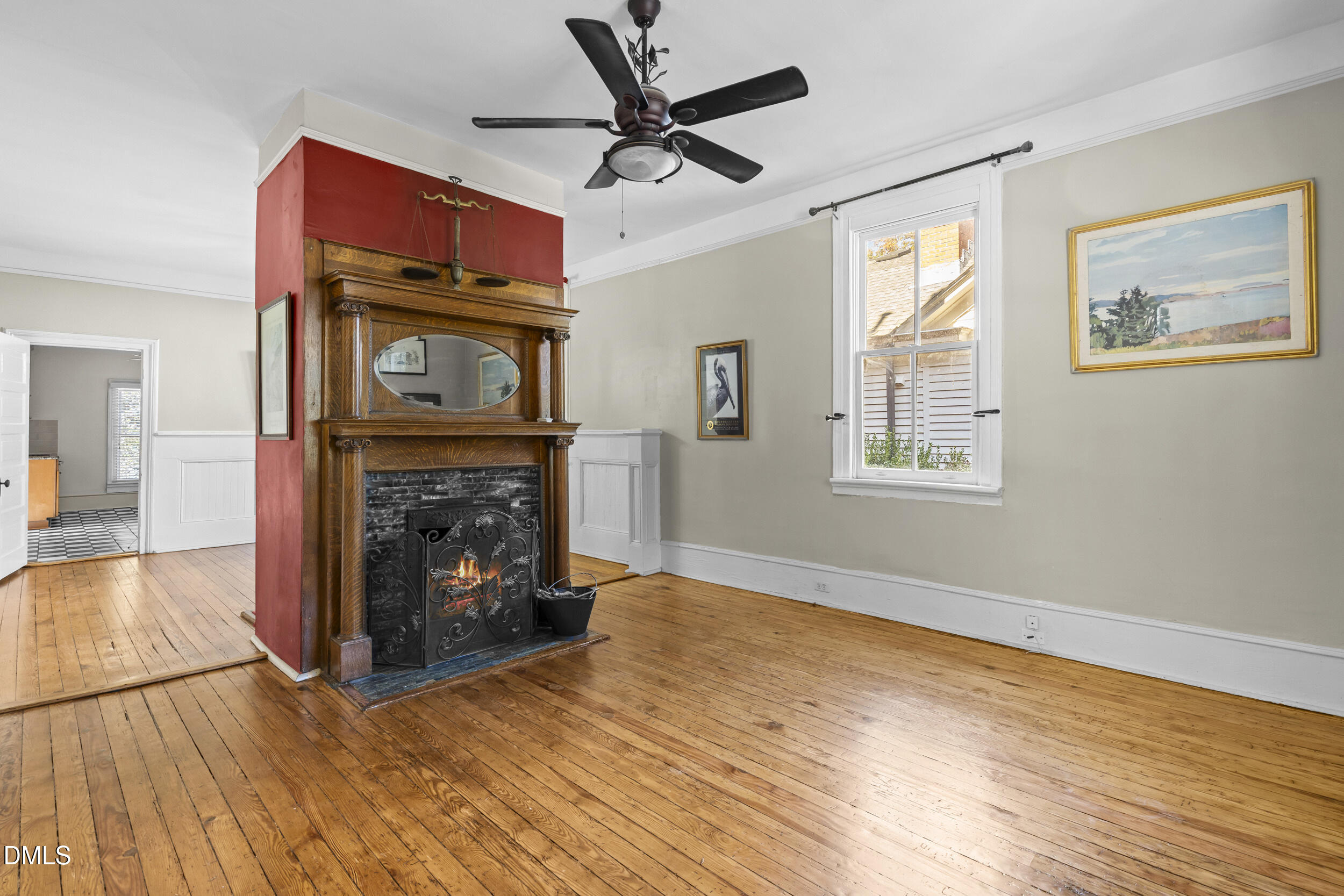 527 North East Street Raleigh, NC 27604 - Photo 8 of 46 a view of a livingroom with a fireplace a ceiling fan and wooden floor