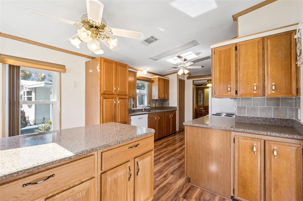 3122 Myakka River Road Tavares, FL 32778 - Photo 11 of 44 a kitchen with stainless steel appliances granite countertop a sink and cabinets