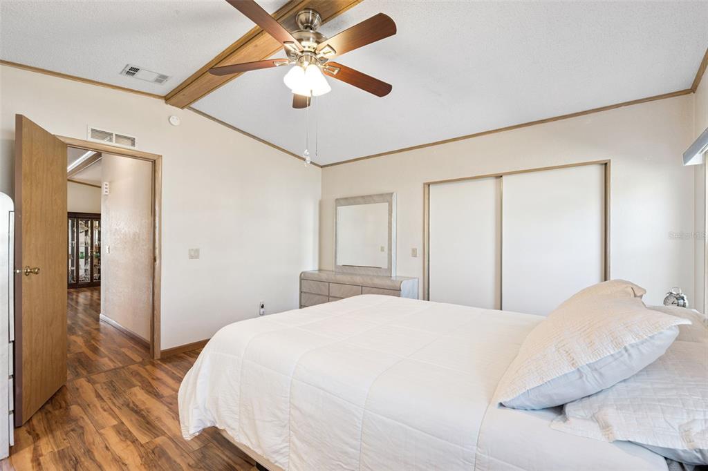 3122 Myakka River Road Tavares, FL 32778 - Photo 15 of 44 a bedroom with a large bed and a chandelier