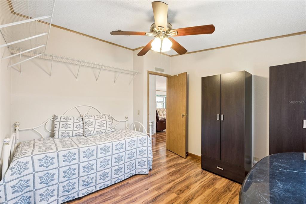 3122 Myakka River Road Tavares, FL 32778 - Photo 17 of 44 a bedroom with bed and wooden floor