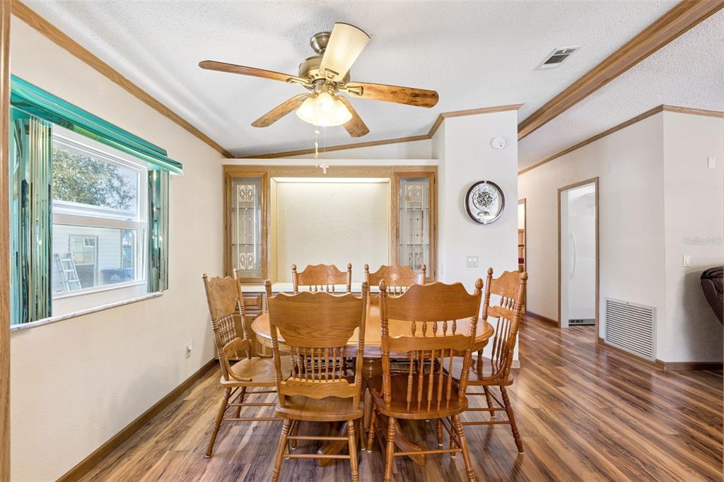 3122 Myakka River Road Tavares, FL 32778 - Photo 6 of 44 a view of a dining room with furniture window and wooden floor