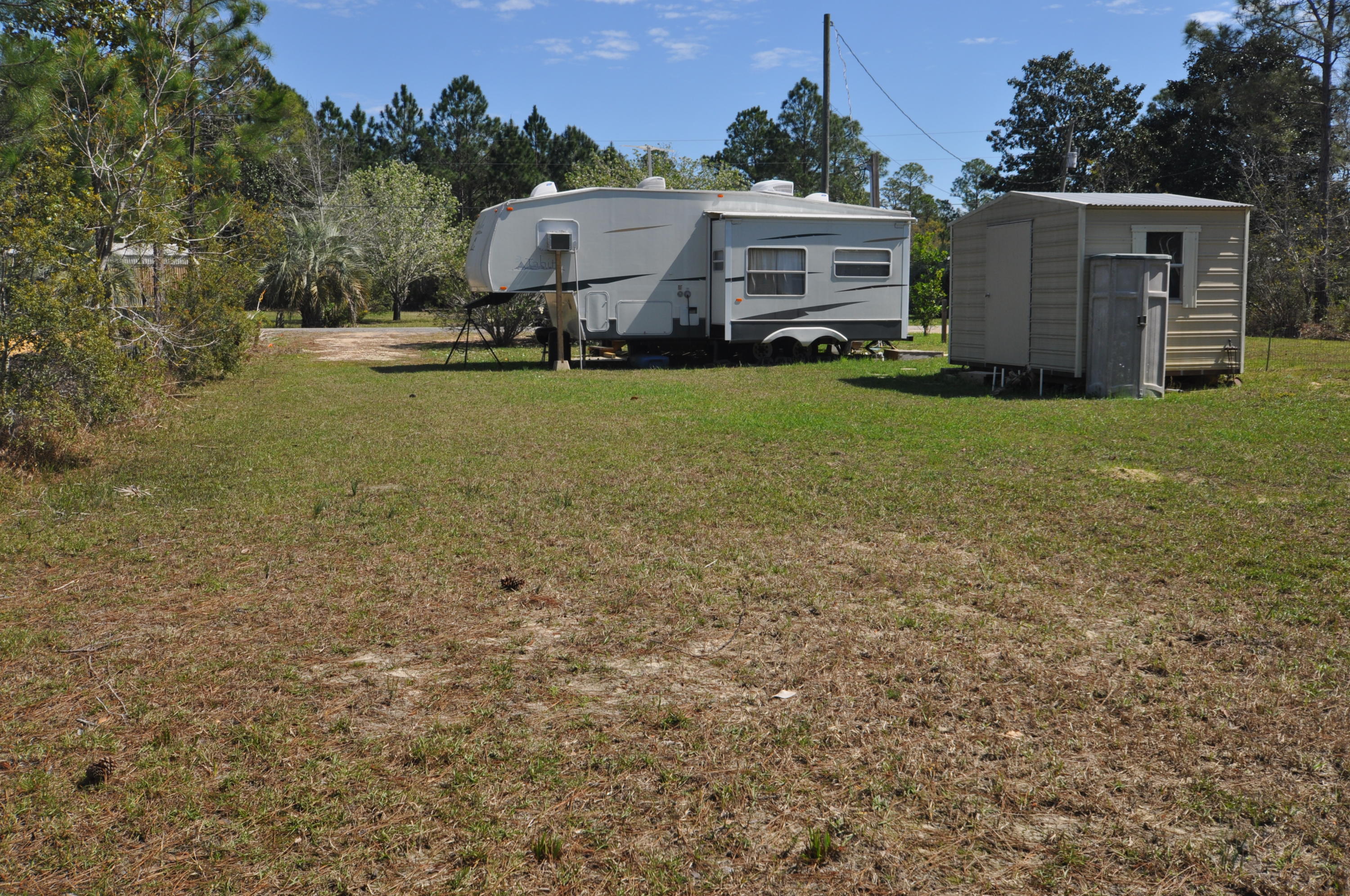 Lot 9 Santa Rosa Street Santa Rosa Beach, FL 32459 - Photo 9 of 11 a front view of house with yard and trees in the background