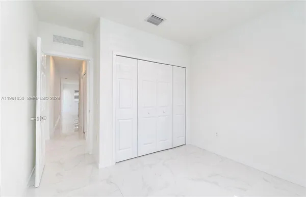 an empty room with a kitchen