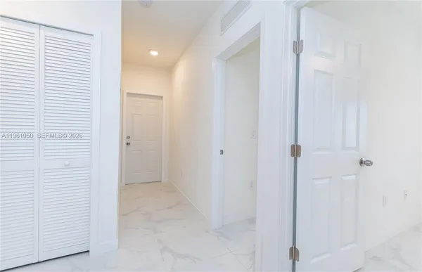 a view of a hallway with closet area
