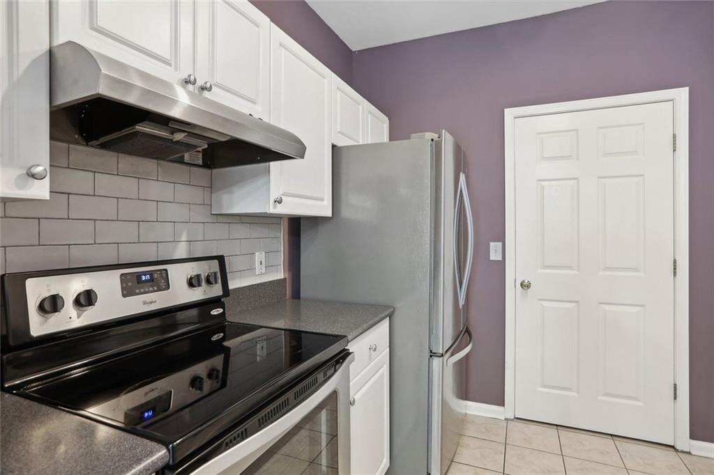 206 Spring Heights Lane, Unit 206 Smyrna, GA 30080 - Photo 14 of 29 a kitchen with stainless steel appliances granite countertop a refrigerator and a stove